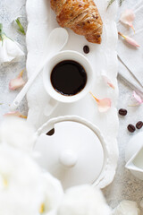 Breakfast tray with coffee cup and croissant
