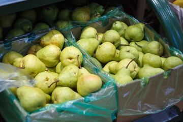 Green pears on the counter of the store
