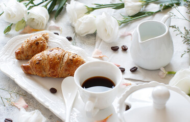 Breakfast tray with coffee cup and croissant