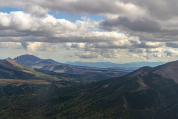 Fototapeta na wymiar Daytime view of the stony wasteland in daytime; View of the volcano on the horizon in clear weather