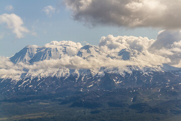Fototapeta premium Daytime view in clear sunny weather of the snow-capped mountain peaks
