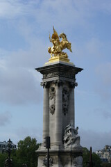 Fototapeta na wymiar Statue on top of a pillar of Pont Alexandre III. Paris