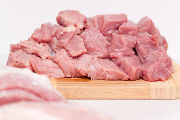 Raw pork belly pieces on a cutting board. Preparing, cooking.