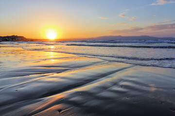 Unbelievable sunrise. Beautiful summertime view seascape. The wet sand on the sea coast. Morning landscape. High waves with foam. Widescreen frame backdrop. Location place island Crete, Greece.