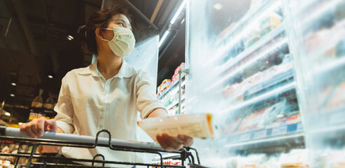 new normal after covid epidemic young smart asian female shopping new lifestyle in supermarket with...