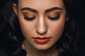 Close-up, portrait of a beautiful female face with extreme long-lash makeup.