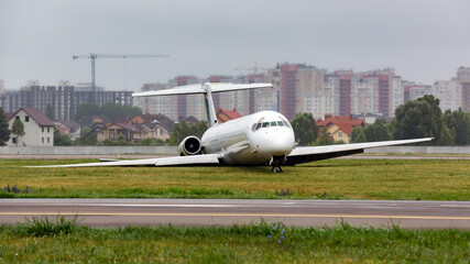 White plane lies on grass after crash