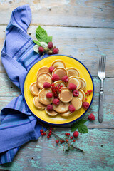mini pancakes with fruits on a plate