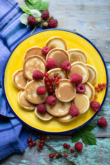 mini pancakes with fruits on a plate