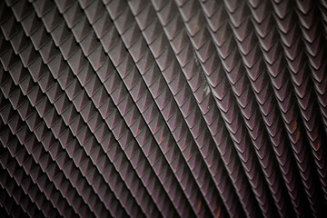 Abstract black geometric texture or background. Diamond-shaped soundproofing in modern music or media studio.