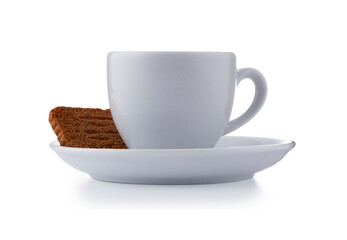 White expresso cup and saucer full of smooth expresso coffee, with a biscuit, isolated on white