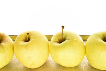 Yellow apples, close-up, on a white background.