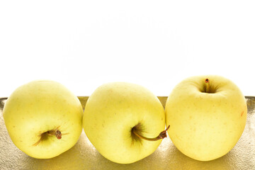 Yellow apples, close-up, on a white background.