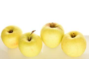 Yellow apples, close-up, on a white background.