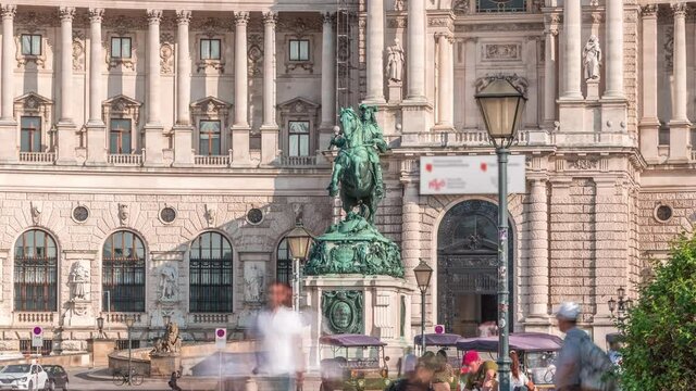 Equestrian statue of Prince Eugene of Savoy timelapse (Prinz Eugen von Savoyen) in front of Hofburg palace, Heldenplatz, Vienna, Austria. People walking around