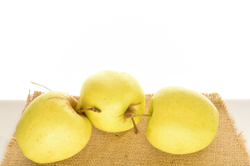 Yellow apples, close-up, on a white background.