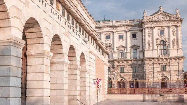 Exterior of outer castle gate (Burgtor) from Ringstrasse timelapse in Vienna city in sunny day. Blue cloudy sky. The gate of Hofburg area was erected in 1818