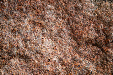 Granite texture, granite background, granite stone closeup on an unpolished real flat stone surface level.