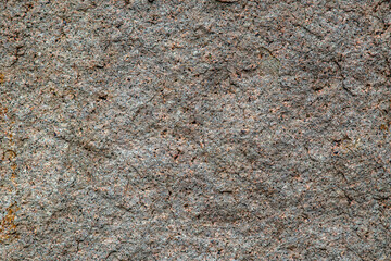 Granite texture, granite background, granite stone closeup on an unpolished real flat stone surface level.