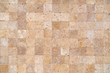 Wall background with Yellow natural sandstone tiles stiched together with clay