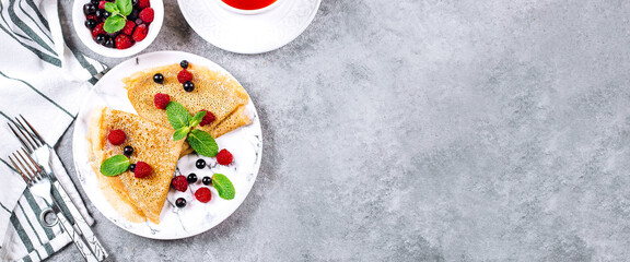 Delicious Crepes Breakfast. Orthodox Holiday Maslenitsa. Pancakes with berry currant, raspberry