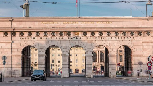 Exterior of outer castle gate (Burgtor) from Ringstrasse timelapse in Vienna city in sunny day. Blue cloudy sky. The gate of Hofburg area was erected in 1818