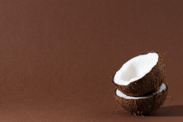 Ripe half cut coconut on a wooden background. Ripe half cut coconut on a wooden background. Coconut cream and oil.