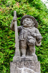 Statue of a male dwarf (carved by workshop of baroque sculptor Matthias Bernard Braun) in the garden of the castle Nove Mesto nad Metuji, Czech republic.
