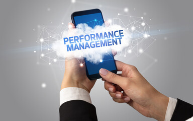 Female hand touching smartphone with PERFORMANCE MANAGEMENT inscription, cloud business concept