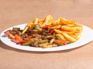 A nice plate of roasted chicken, seasoned with herbs, pepper, salt, oregano, and garlic. Also accompanied by vegetables fried on olive oil.
Accompanied by French fries on a white plate.