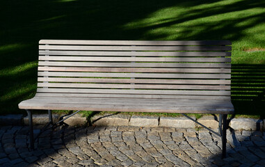 garden park bench metal comfortable with construction with ergonomic curves of thin wood slats...