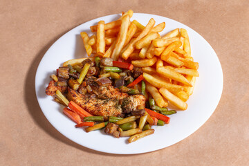 A nice plate of roasted chicken, seasoned with herbs, pepper, salt, oregano, and garlic. Also accompanied by vegetables fried on olive oil.
Accompanied by French fries on a white plate.