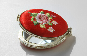 little pocket mirror isolated on white background