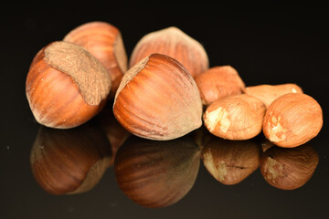 Hazelnuts, macro, on a black background.