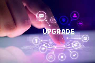 Finger touching tablet with web technology icons and UPGRADE inscription, web technology concept