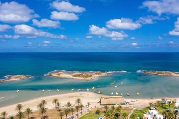 Small Fishing Boats anchored in a shallow lagoon, with packed Fish net onboard, Aerial image.