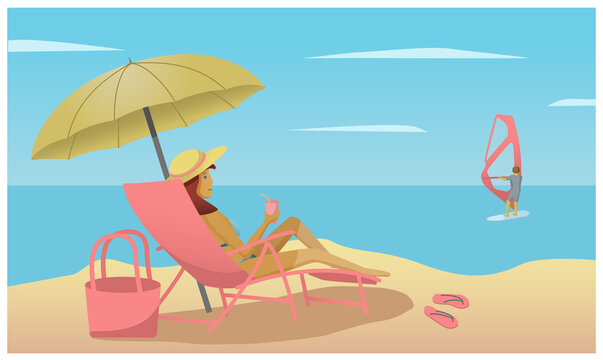 girl on the beach under an umbrella lying in a chaise longue and looking at the windsurfer