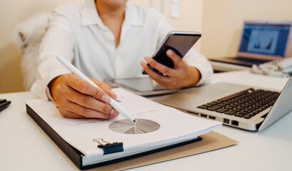 businesswoman hand using smart phone, tablet payments and holding credit card online shopping, omni channel, digital tablet docking keyboard computer at office in sun light with film grain effect