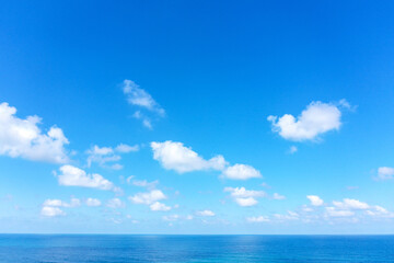 Fototapeta na wymiar Aerial view of clear Ocean water with blue cloudy sky. 