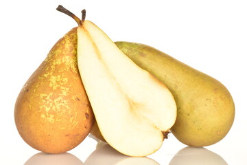 One juicy half of a pear in focus, in the center and two whole pears, close-up, isolated on white.