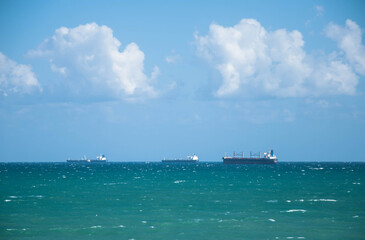Ships on the horizon of the sea on a background of blue sky