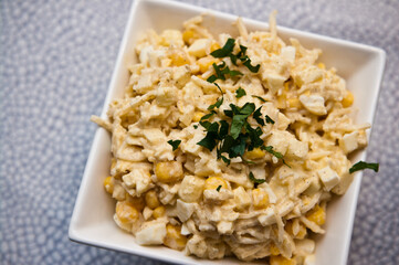 Bowl of vegetable salad of corn apples cellery and spices