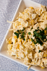 Bowl of vegetable salad of corn apples cellery and spices