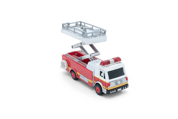 Children's toy Red fire truck with lift tower close up on white background