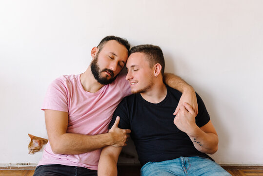 Gay couple hugging with pet.