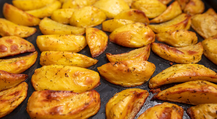 Baked potatoes in the oven as a background.