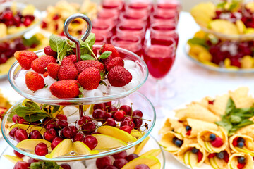 Close-up plate with berries, strawberries. raspberries, cherries, blueberries, and baked goods. Buffet table at the festival. Catering concept