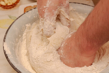 Fototapeta premium Cooking dough in a white metal bowl at home