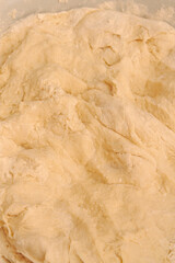 Raw dough mixed in a bowl for making homemade dumplings