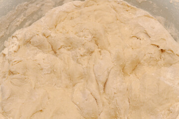 Raw dough mixed in a bowl for making homemade dumplings